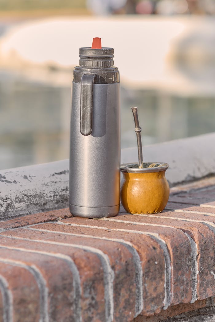 A thermos and traditional mate cup on a brick wall in Montevideo, Uruguay.